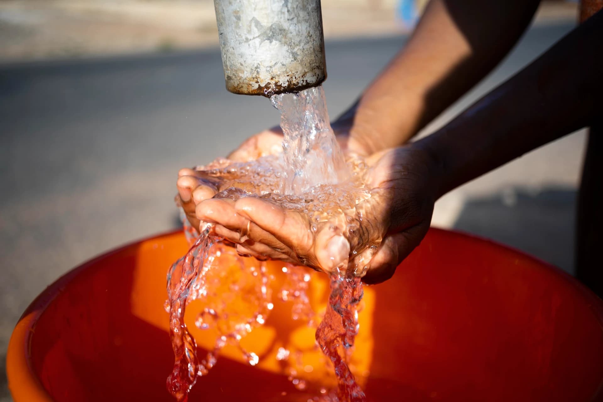 A person collecting clean drinking water
