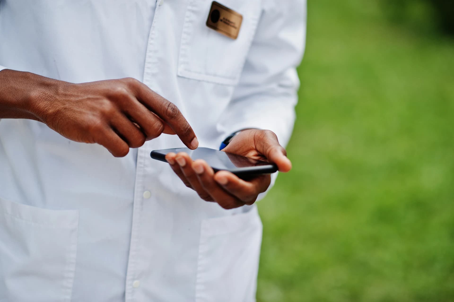 A person entering data on a mobile phone during a frontline interview