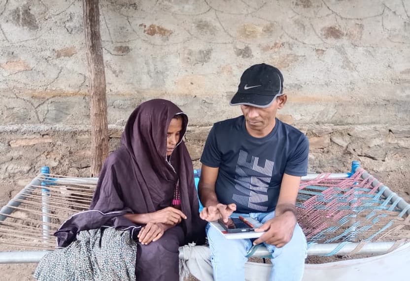 Frontline workers helping community members record voice-note interview responses